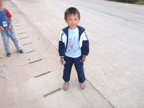 taking pictures and showing these curious boys some of the photo images.